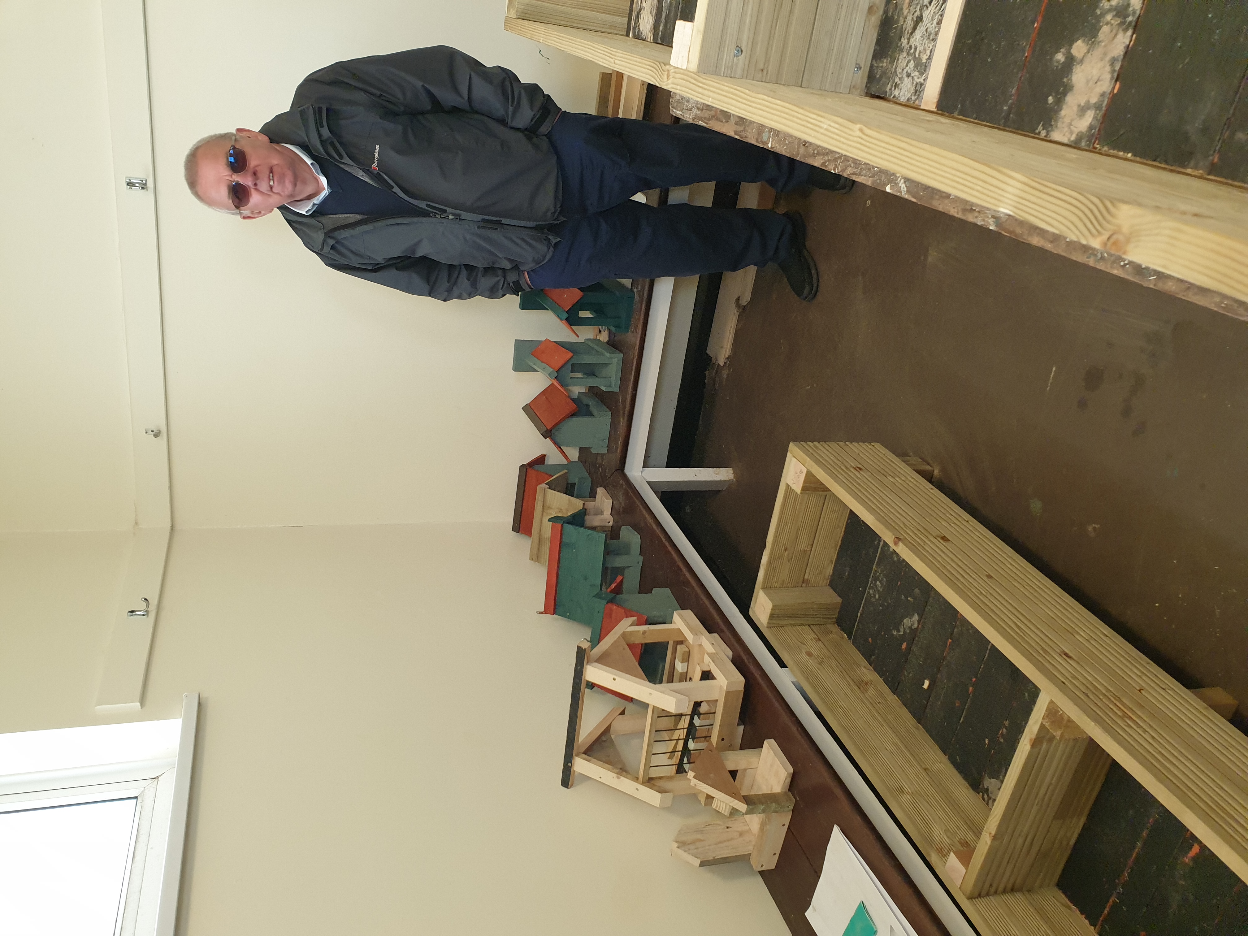 picture showing part of a completed planter built by the Men in Sheds along with completed and painted Bird box's