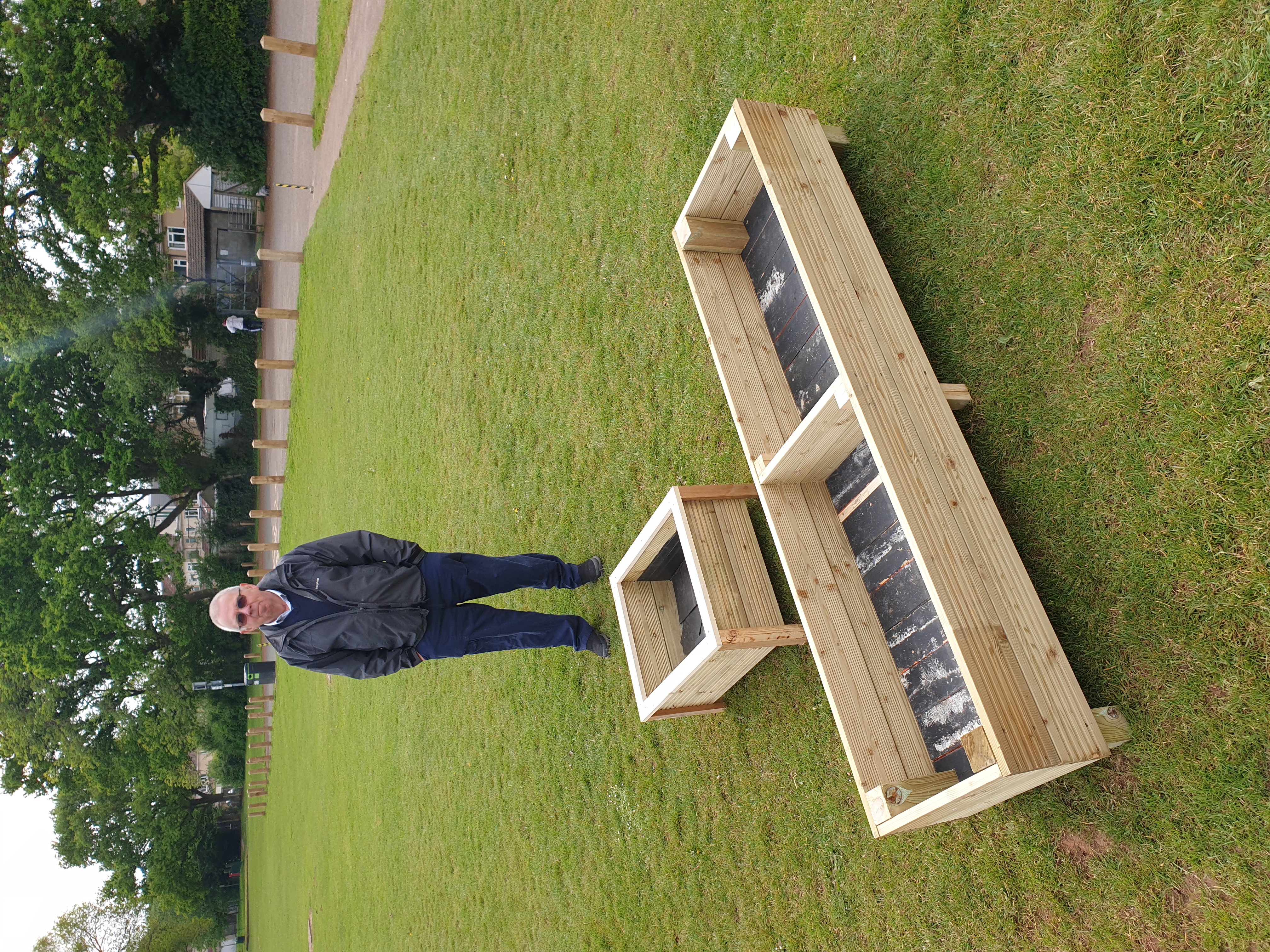 a member of Men In Sheds displaying 2 different newly made planters