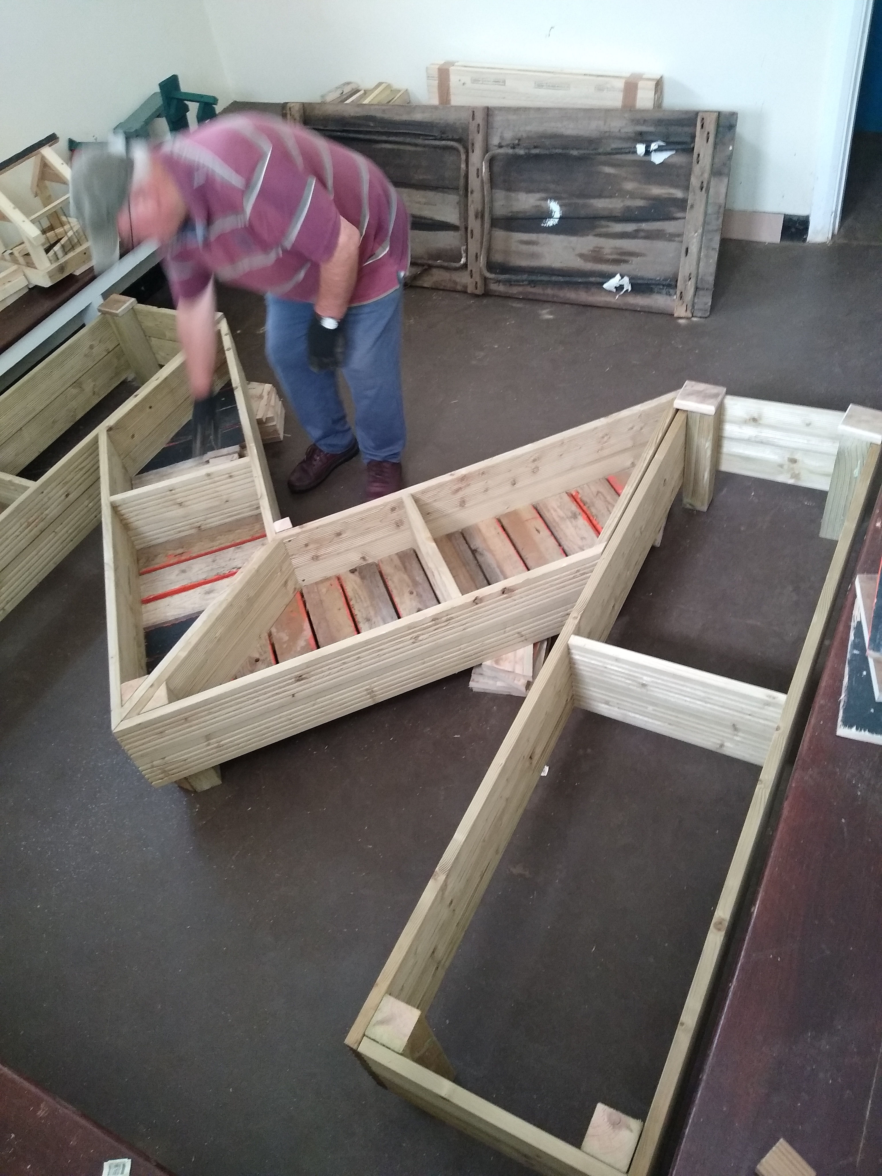 One of Men In Sheds assembling a letter M Planter