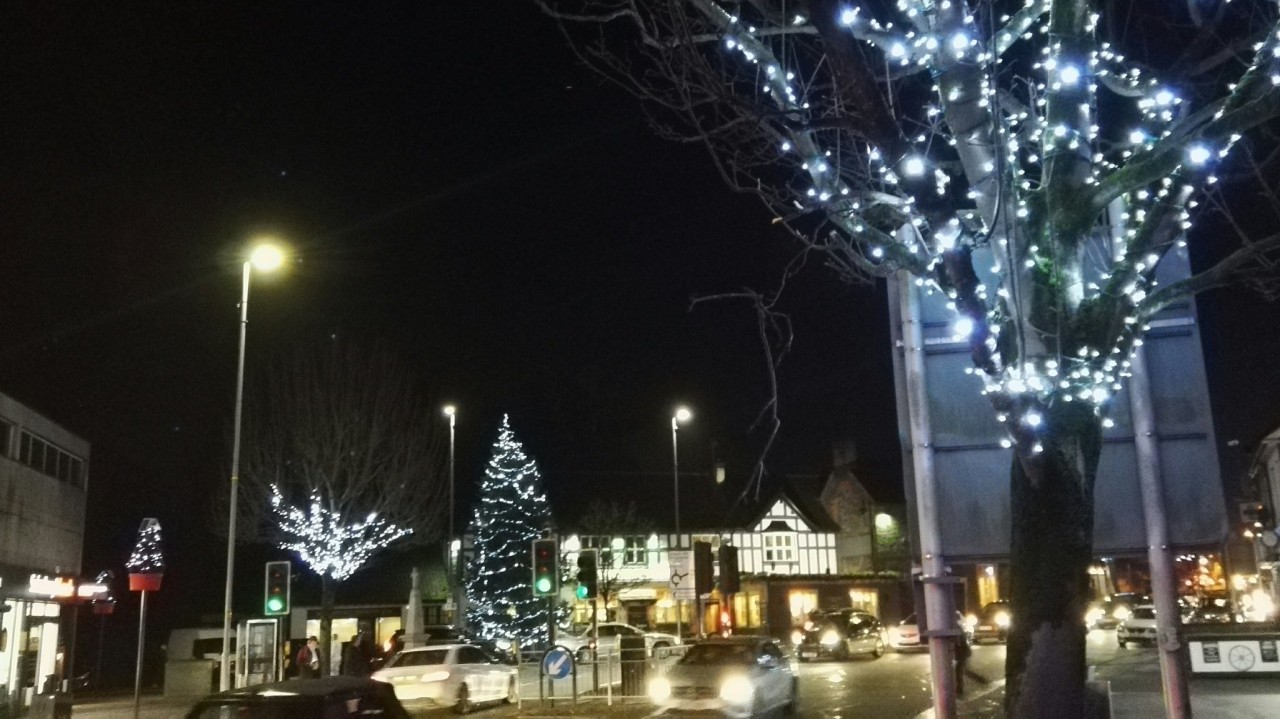 a view of the white led christmas lights in the trees on the Badminton Road and the lit Christmas tree out side the Horse Shoe Pub.