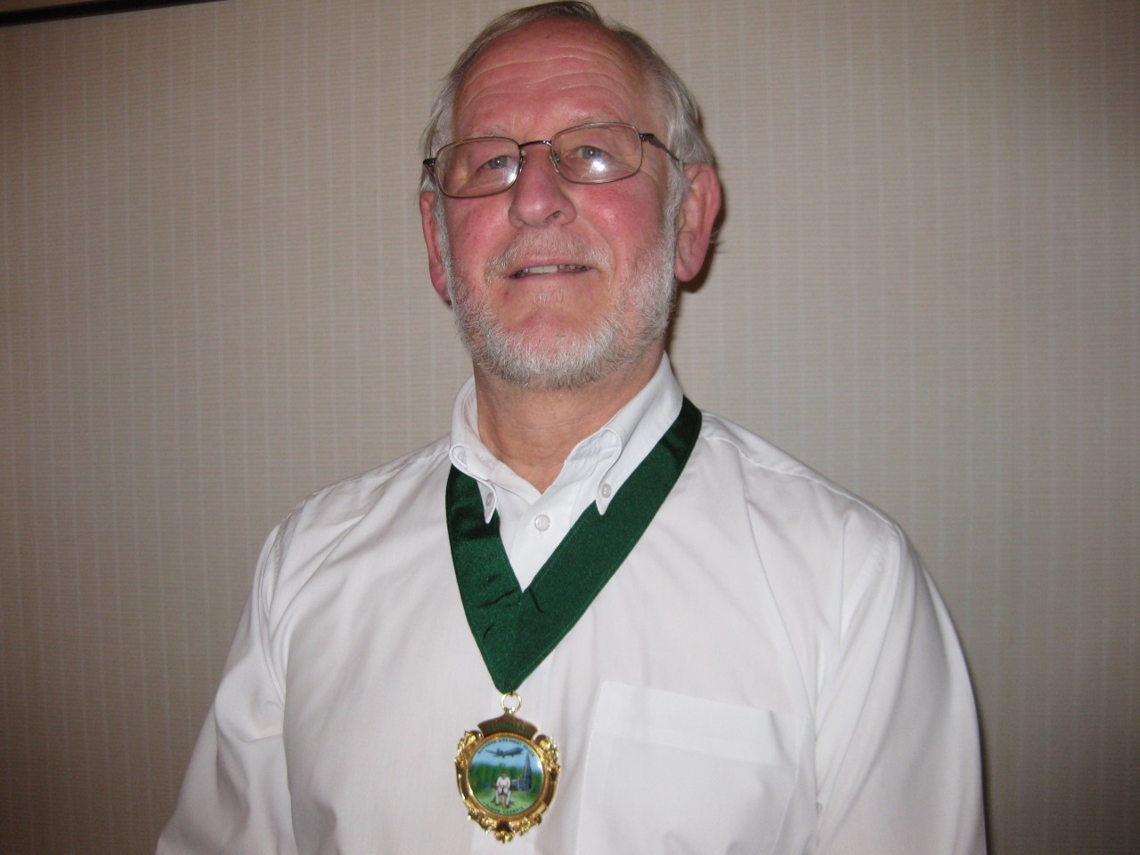 A picture of Graeme Riley wearing the chain of office as chair of the parish council