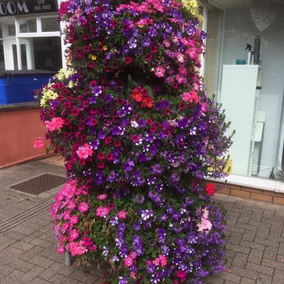 3 tier planter with a beautiful display of flowers cascading down.